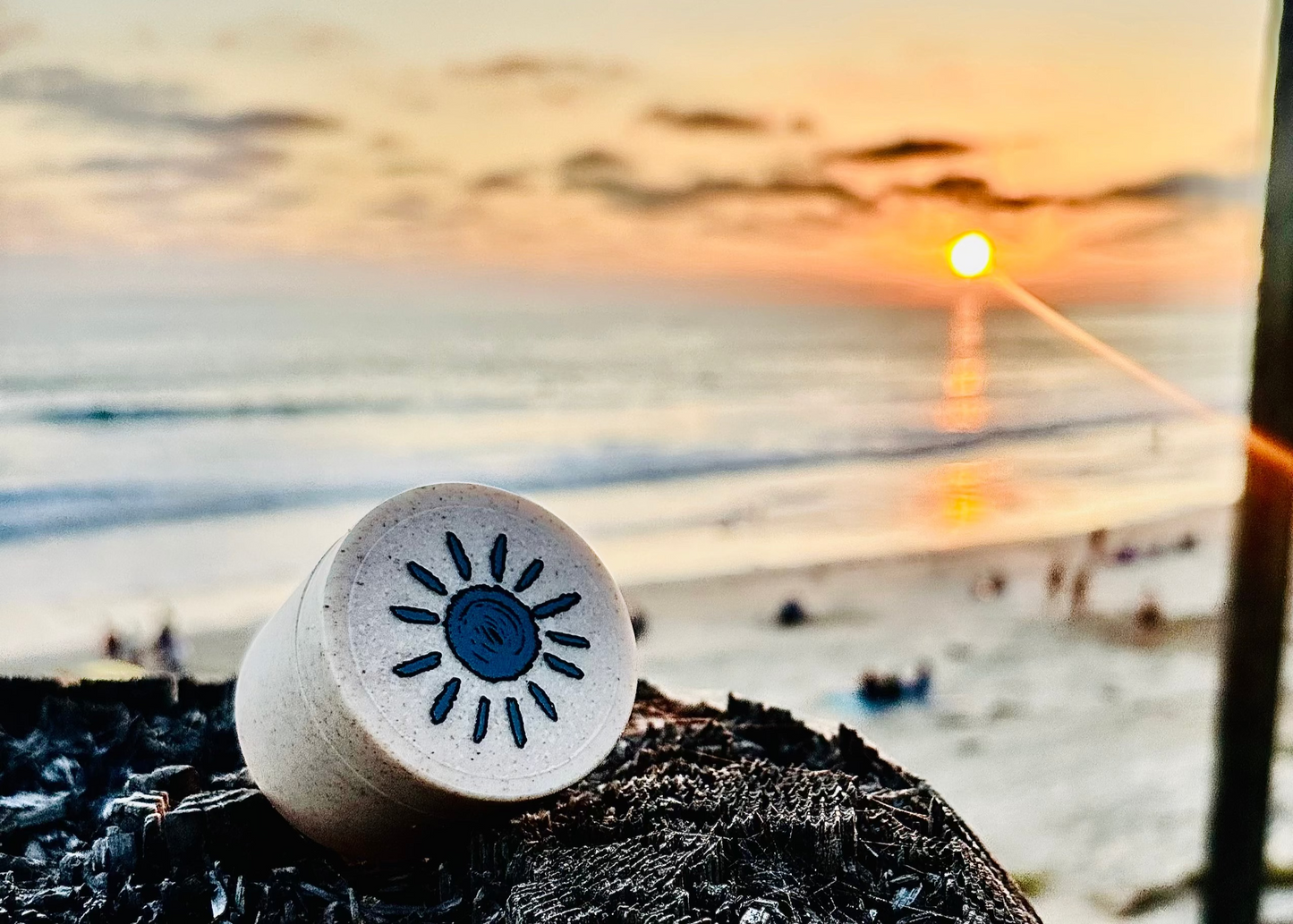Cork with sun design on a beach at sunset